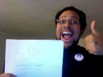 A picture of me giving a 'thumbs up', holding a sign that says "I <3 IntegralMath"